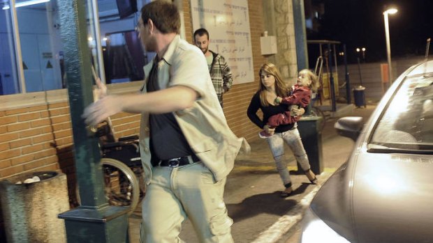 Vicious cycle ... Israelis run for a bomb shelter.