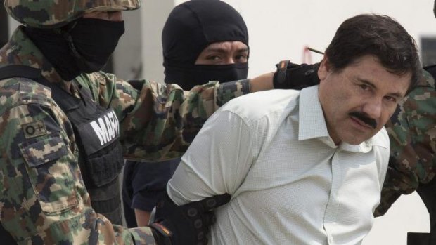 Joaquin "El Chapo" Guzman  is escorted by Mexican security forces in Mexico City.