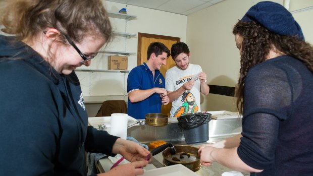 ANU archaeology students brush grime from Springbank treasures. Photo by Stuart Hay.