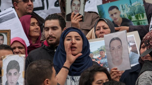 A young Tunisian woman chants slogans in the capital Tunis at an event marking the sixth anniversary of  the overthrow of dictator Zine al-Abidine Ben Ali.  