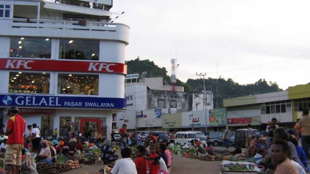 Indigenous traders sell produce in Jayapura, where migrants own many businesses.