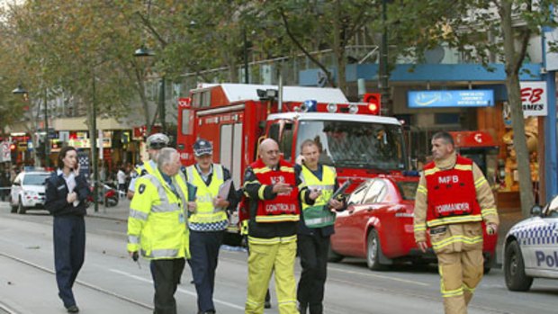 Police and fire officers in Swanston Street after fumes caused evacuations in the city.