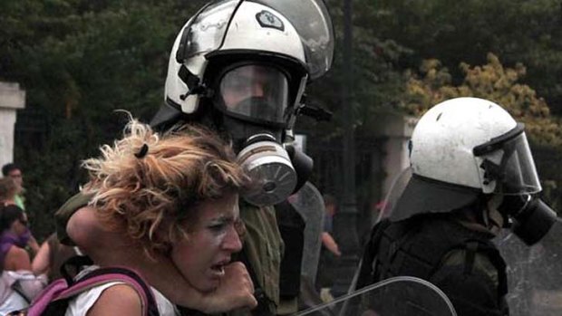 A woman was reportedly used as a human shield by authorities during a protest in Athens.