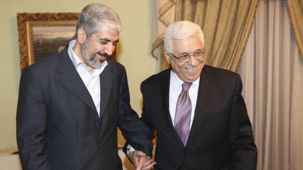 Reconciliation ... Khaled Meshaal, left, and Mahmoud Abbas shake hands.