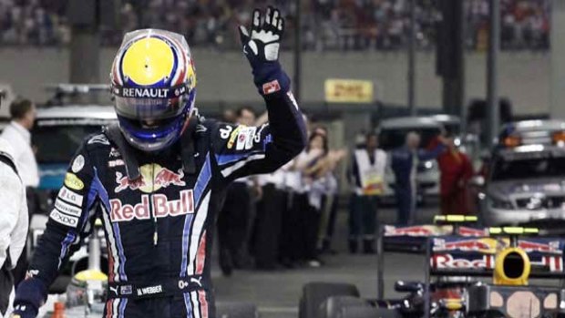 Mark Webber manages a wave for his supporters as he walks from his Red Bull car after seeing his hopes of the world drivers' title disappear in Abu Dhabi.