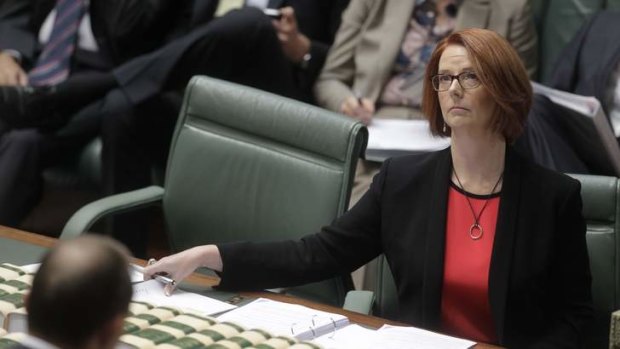 Prime Minister Julia Gillard reacts to a question on her judgment from Opposition Leader Tony Abbott.