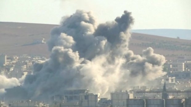 War zone: Large plumes of smoke billowing from the Syrian border town of Kobane following a coalition air strike targeting Islamic State militants.