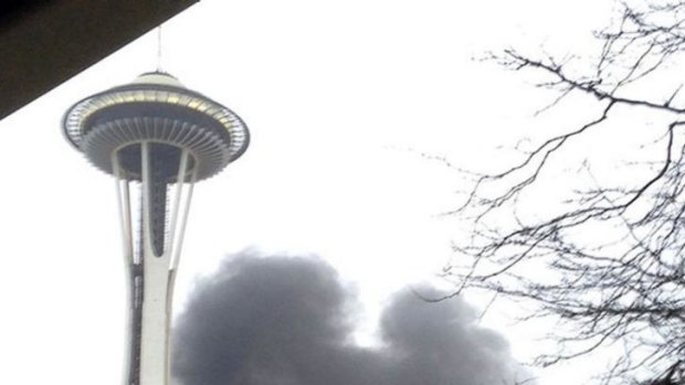 Station tragedy: smoke rises at the scene of the crash outside the studios near the Space Needle in Seattle.