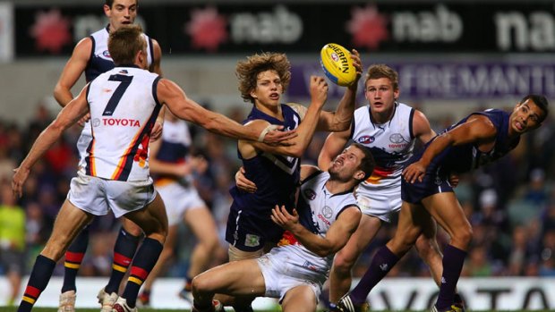 Fremantle's Nathan Fyfe gets a handball away against the Crows