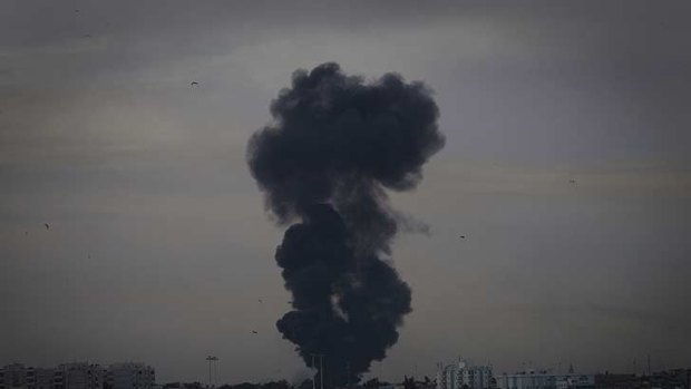 Smoke billows over the outskirts of Benghazi, eastern Libya, after a warplane was shot down Saturday.
