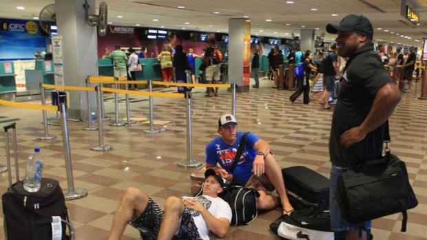 Delayed ... Adam MacDougall, Rhys Wesser and Matt Cross were stranded with other tourists at Nadi airport as flights were delayed and cancelled.
