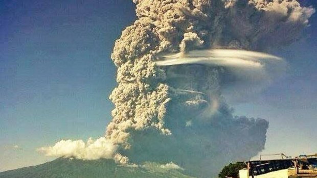 Ash spews from the Sangeang Api volcano off the north-east coast of the Indonesian island of Sumbawa.
