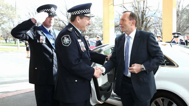 Prime Minister Tony Abbott is greeted by AFP Commissioner Tony Negus at the swearing-in of new AFP officers in Canberra.
