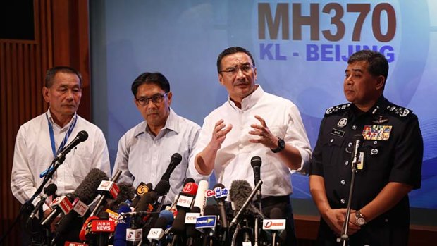 Hijacking a possibility: Malaysia's acting Transport Minister, Hishammuddin Hussein, second from right, speaks at a news conference on Sunday night.