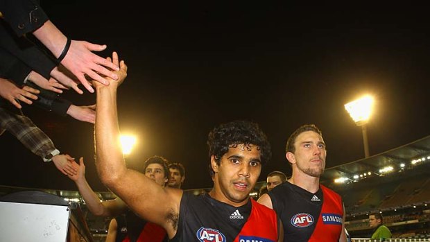 High fives all round: Essendon's Alwyn Davey is congratulated by the some of the MCG crowd after the Bombers' 39-point win over Richmond.