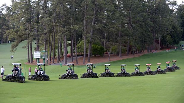 Lawn-mowers come down the fairway during a practice round at the Augusta National Golf Club.