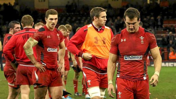 Unhappy: Sam Warburton leads Wales off the field.