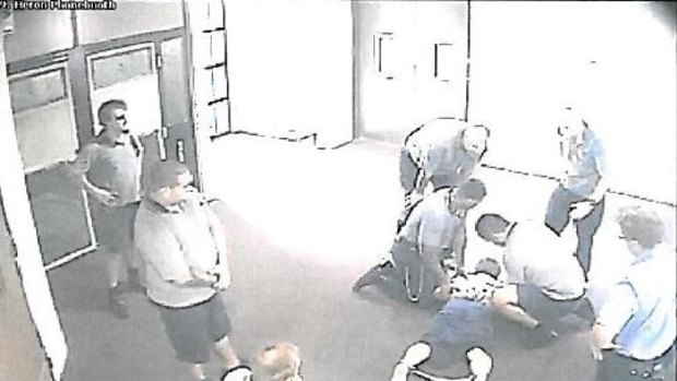 CCTV images appear to show a teenager with ankle-cuffs being held down at the Townsville centre.