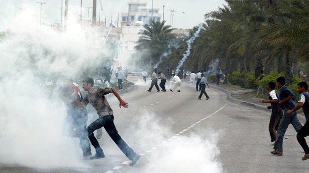 Rioters flee during the Arab Spring protests in Bahrain.