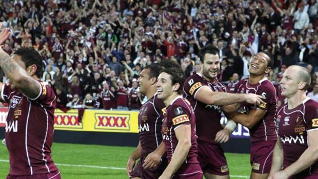 Party time . . . Queensland players soak up the adulation of their adoring fans last night.