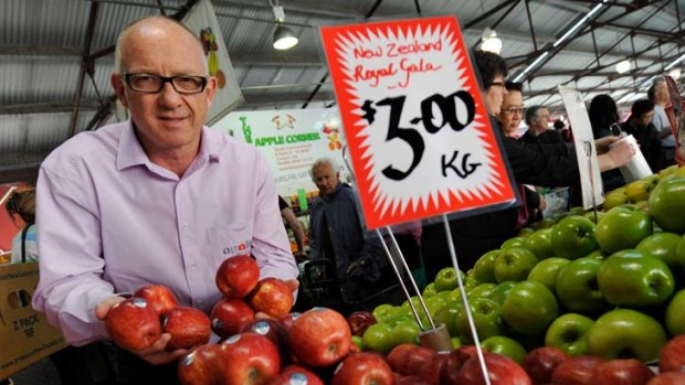 Bruce Beaton shows off his Kiwi apples at the Victoria Market yesterday. He says they are disease-free and will introduce Australians to new varieties of the fruit.