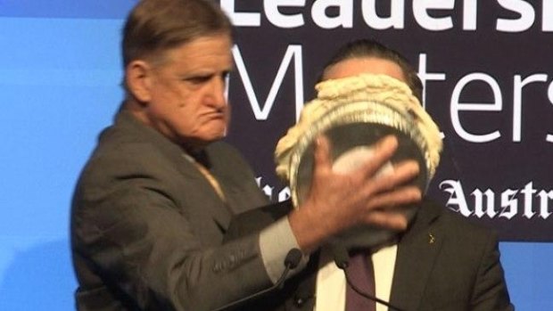 Alan Joyce hit with a pie during an event in Perth.