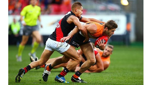 Trapped: Bomber Leroy Jetta puts a strong tackle on Callan Ward.
