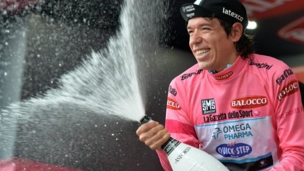 Rigoberto Uran of Colombia celebrates after snatching the pink jersey following his victory in stage 12.