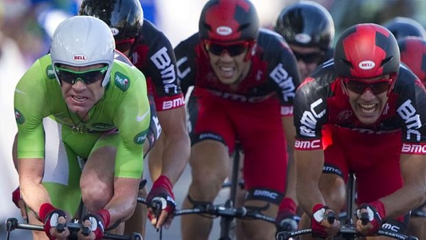 Going strong: Cadel Evans (green jersey) leads his BMC Racing team to second place in stage two of the Tour de France.