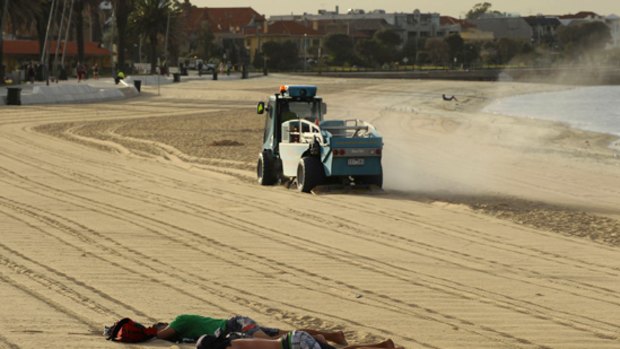 After a hot night, St Kilda beach recieves its morning makeover.