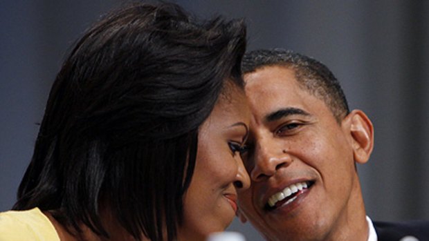 A word in your ear ...  Michelle and Barack Obama.