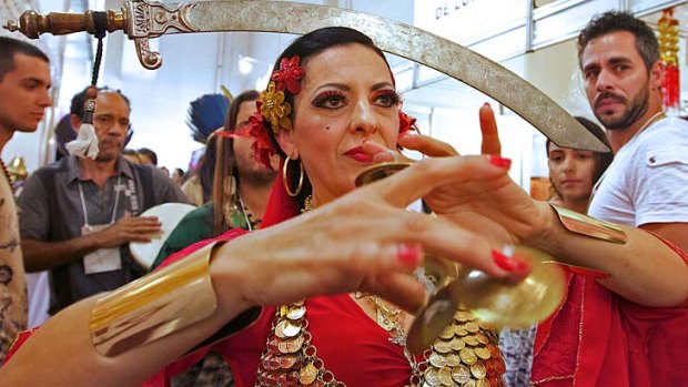 A woman dances during the fourth Mystic Fair, in Sao Paulo, where mystics presented their predictions for 2014, including which country would win the World Cup.