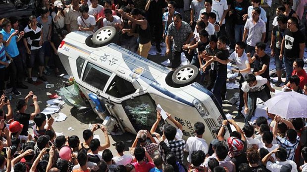 Riots ... demonstrators clash with police in Qidong.