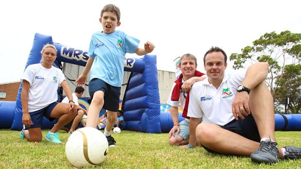 Emphasis on fun &#8230; a Marrickville Public School pupil with, from left, Matildas striker Kyah Simon, the head of the AFDP, Urs Zanitti, and Mr Soccer's Mark Robertson.