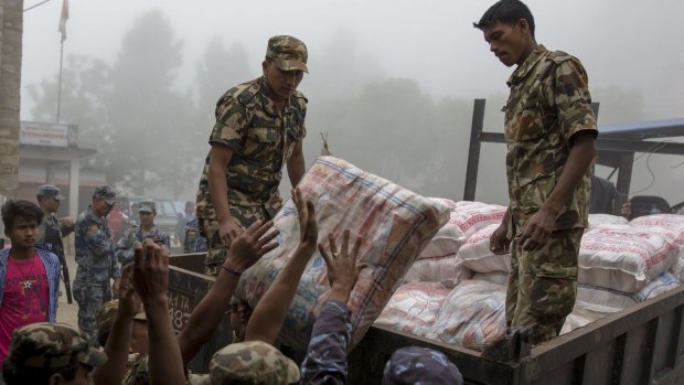 Nepal military personnel load relief supplies onto a truck on Wednesday.