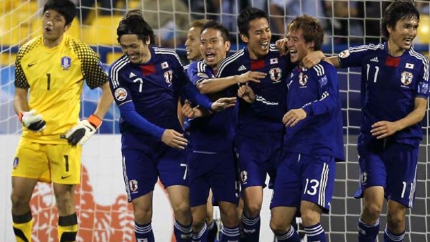 Japan's midfielder Hajime Hosogai (2nd-R) celebrates with teammates after scoring his team's second goal.