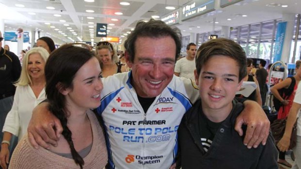 Pat Farmer is reunited with his family at Sydney Airport yesterday.