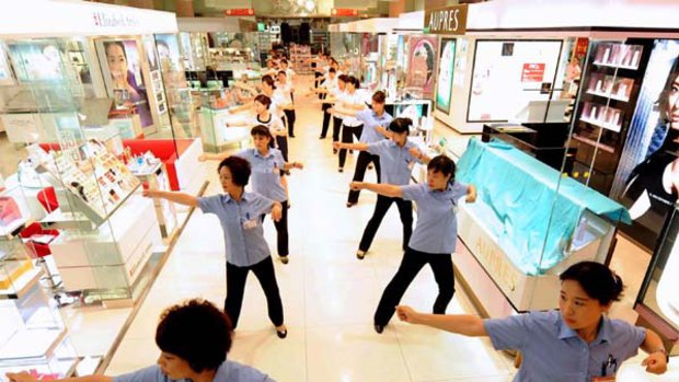 Fit to work: Staff to do exercises at the opening of a mall in Beijing this week. <i>Picture: AFP</i>