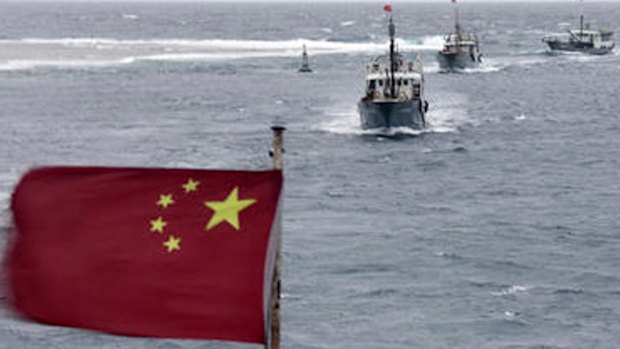 Chinese fishing boats sail in the lagoon of Meiji reef off the island province of Hainan in the South China Sea.