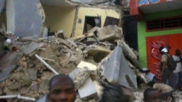 Haitians among rubble from the earthquake that has left more than 100,000 dead.