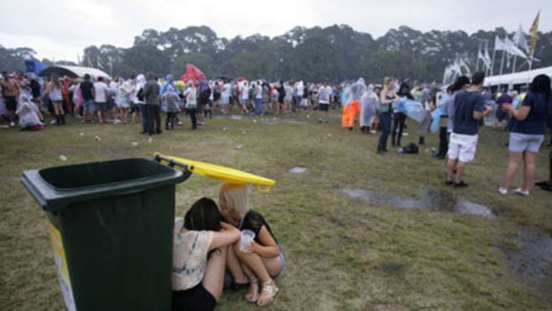 Why does it always rain on me? Girls take cover at Parklife yesterday.