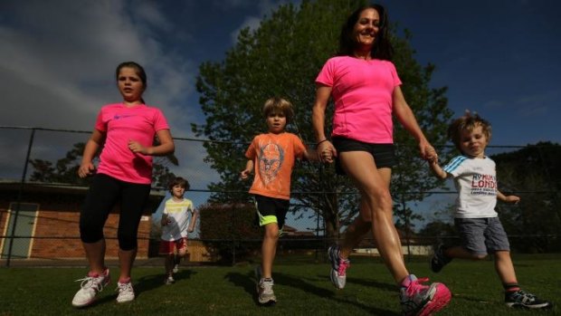 Stephanie Deck, who runs 50 kilometres a week, with her children Holly, 10, Charlie, 5, Luca, 7, and Jude, 3.