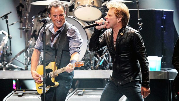 Bruce Springsteen, left, and Jon Bon Jovi share the stage at the 12-12-12 benefit concert.