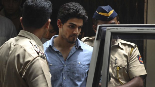 Accused boyfriend Suraj Pancholi, the son of Bollywood couple Aditya Pancholi and Zarina Wahab is escorted by police as he leaves after appearing before a court in Mumbai, India, on Tuesday.