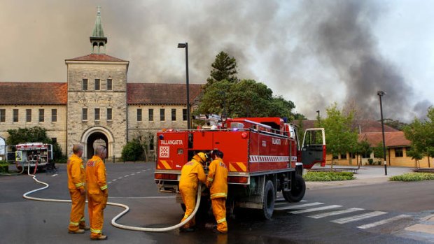 Defence mode: Firefighters go into action near St Columba's School in Winmalee, the Blue Mountains.