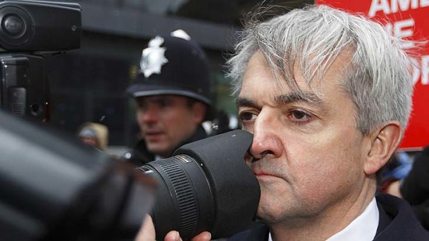 Caught by the camera again: Chris Huhne arrives at the Southwark Crown Court before sentencing.
