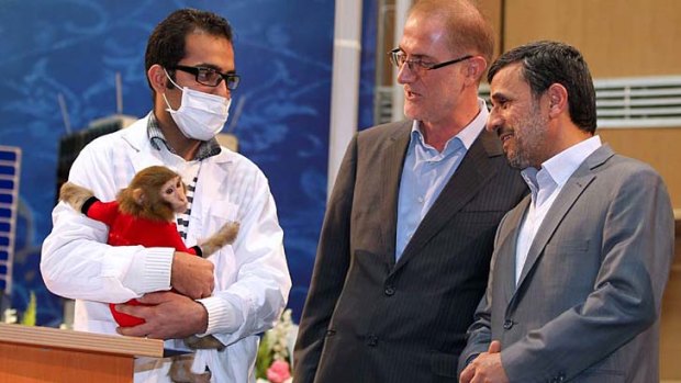 Rocket man ... President Mahmoud Ahmadinejad, right, catches up with Pishgam the space monkey.