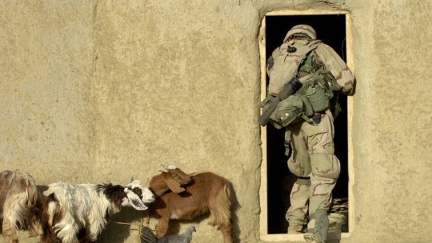 A US soldier in the Task Force Panther 82nd airborne searches a room in a mud compound in the southeastern Afghanistan village of Masi Kalay, near the Pakistan border.