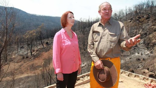 Fire survivors: Bob Fenwick with then prime minister Julia Gillard at his burnt-out property in January.