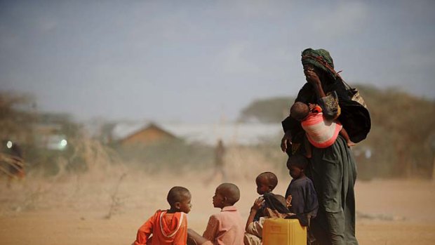 Sarura Ali and her six children wait outside a food distribution point in Kenya.